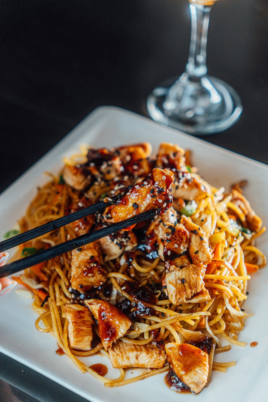 delicious teriyaki chicken noodles with chopsticks